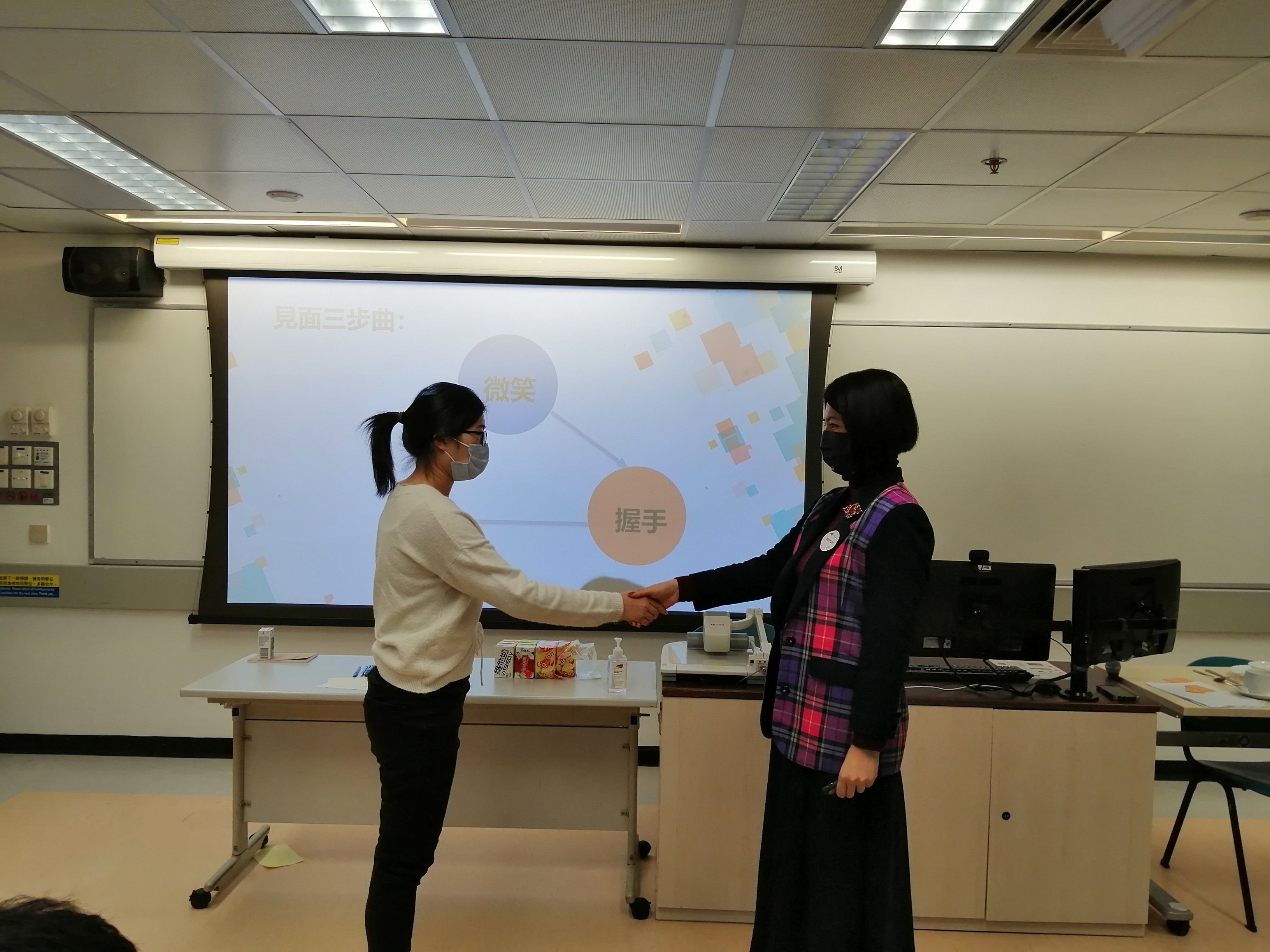 Tutor was teaching students how to shake hands