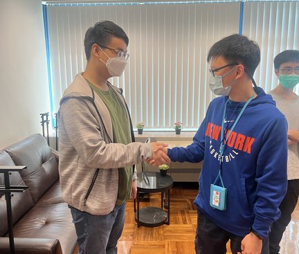 Students are practicing how to shake hands.