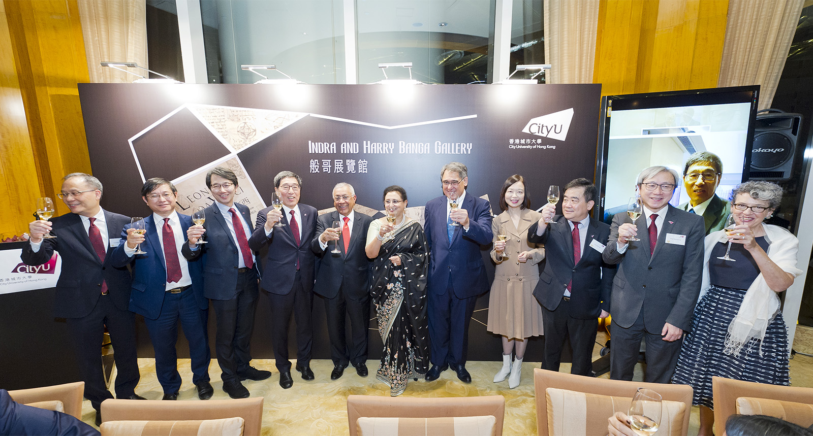 Guests raise a toast at the naming ceremony.