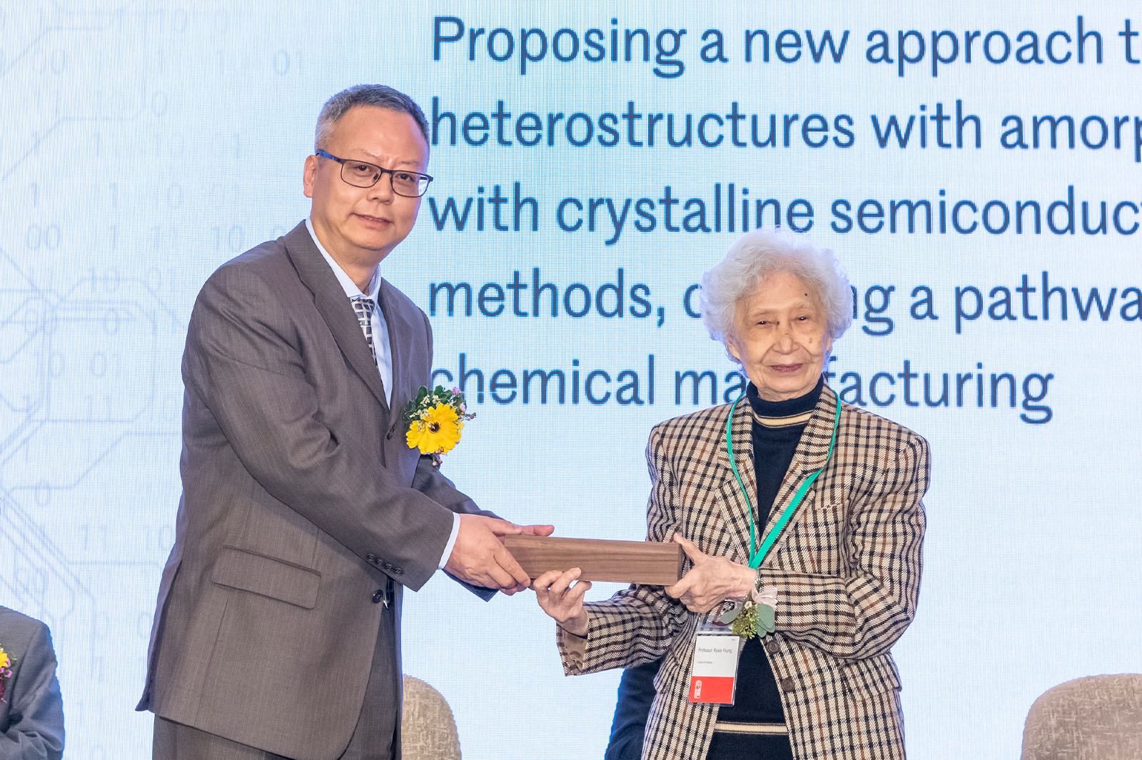 Professor Zhang receives the award from Professor Rosie Young, world-renowned physician.