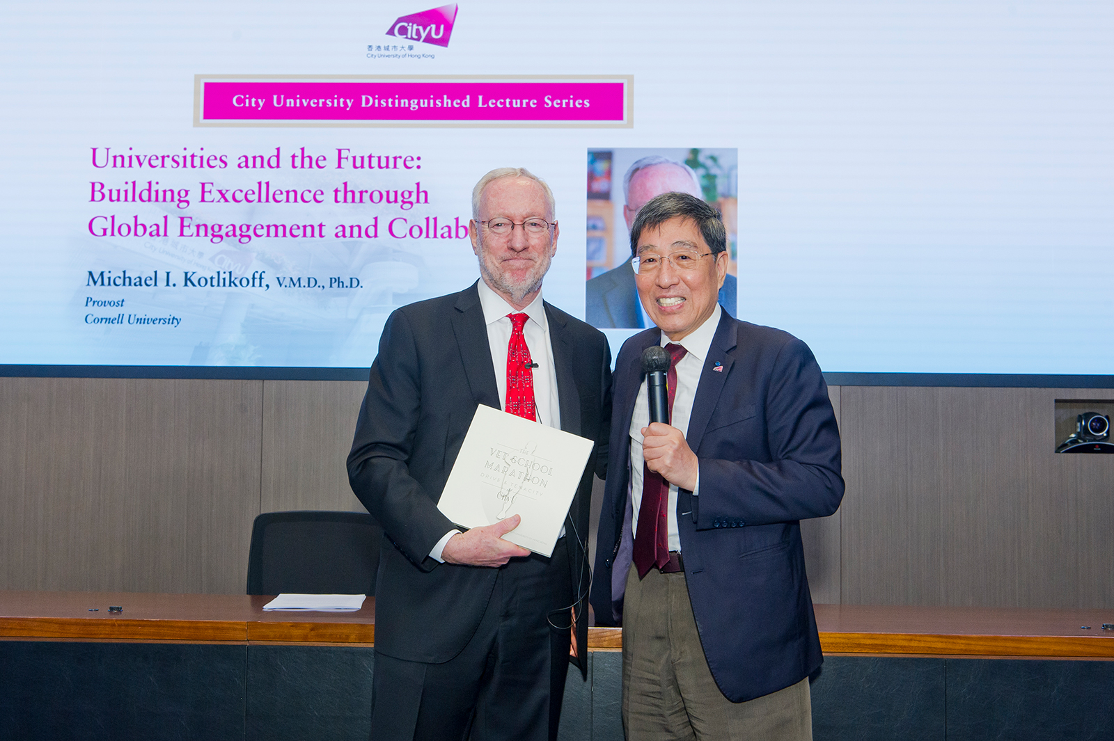 President Kuo (right) presents Professor Kotlikoff with a copy of the recently published book, The Vet School Marathon: Drive and Tenacity at CityU. President Kuo presents Professor Kotlikoff with a copy of the recently published book, The Vet School Marathon: Drive and Tenacity at CityU.