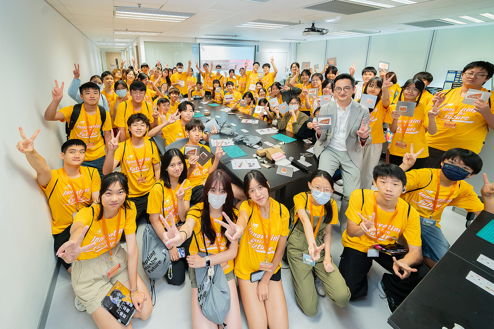 The participating students learn how to build a simple antenna in a workshop hosted by Professor Wong (second row, fourth right).
